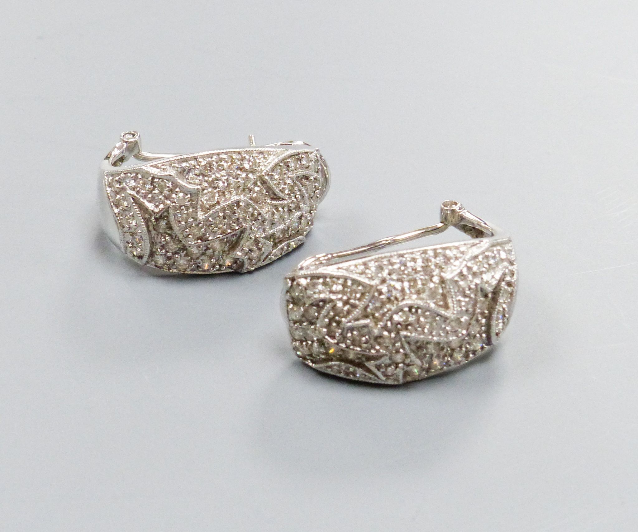 A modern pair of 18k white metal and pave set diamond demi-lune earrings, 21mm, gross 9.7 grams.